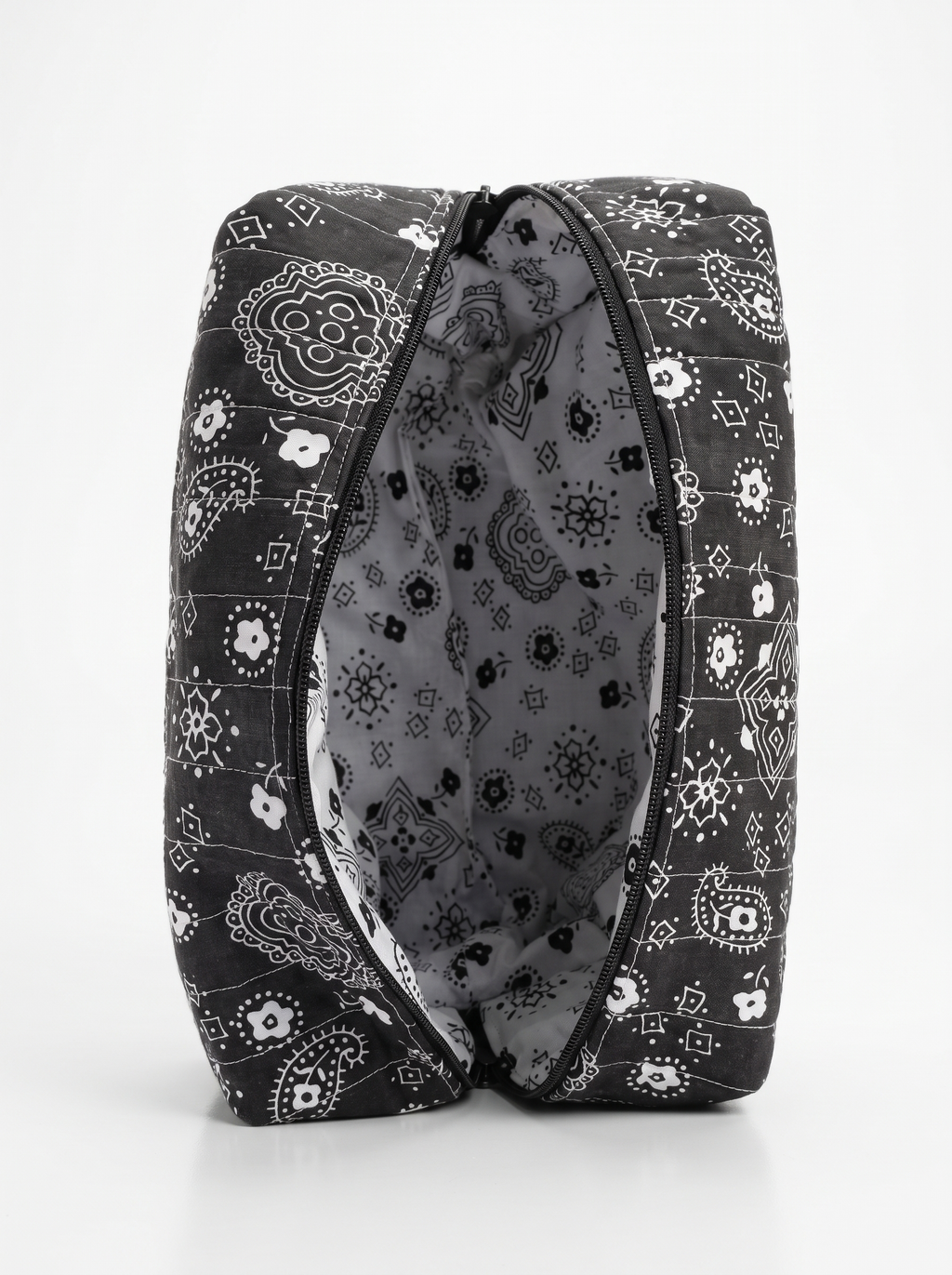 A black and white patterned zippered pouch shown open against a clean white background.