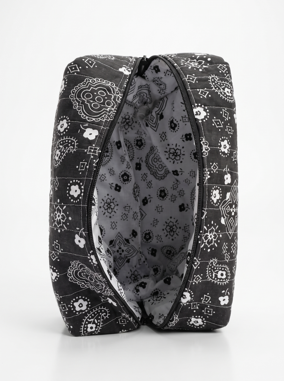 A black and white patterned zippered pouch shown open against a clean white background.