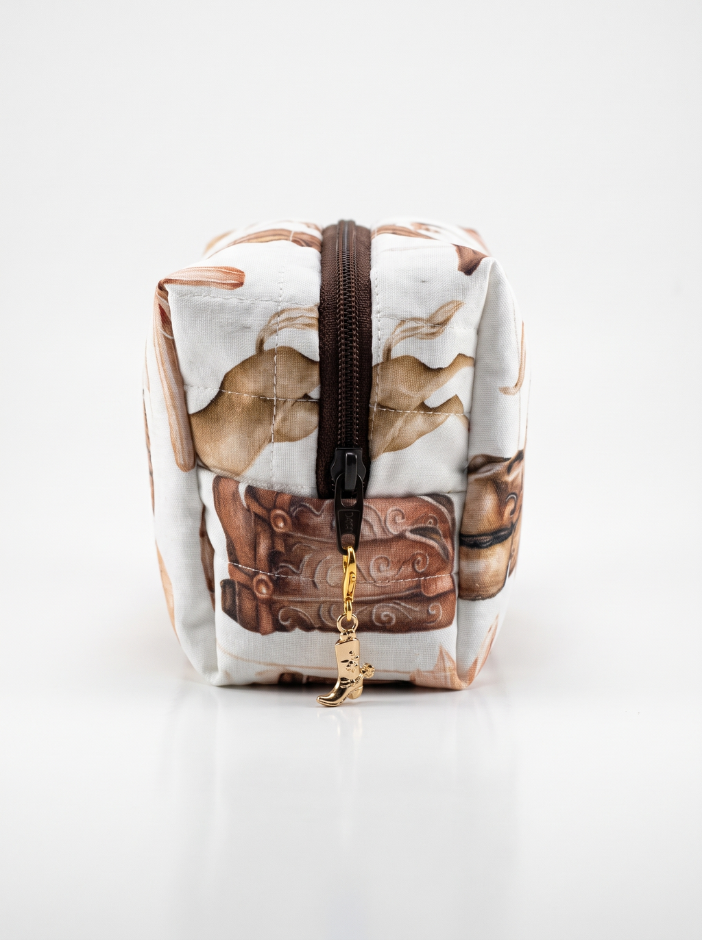 A small zippered pouch with a brown and beige embossed-style print on a white background, featuring a dark brown zipper and a gold-tone charm.