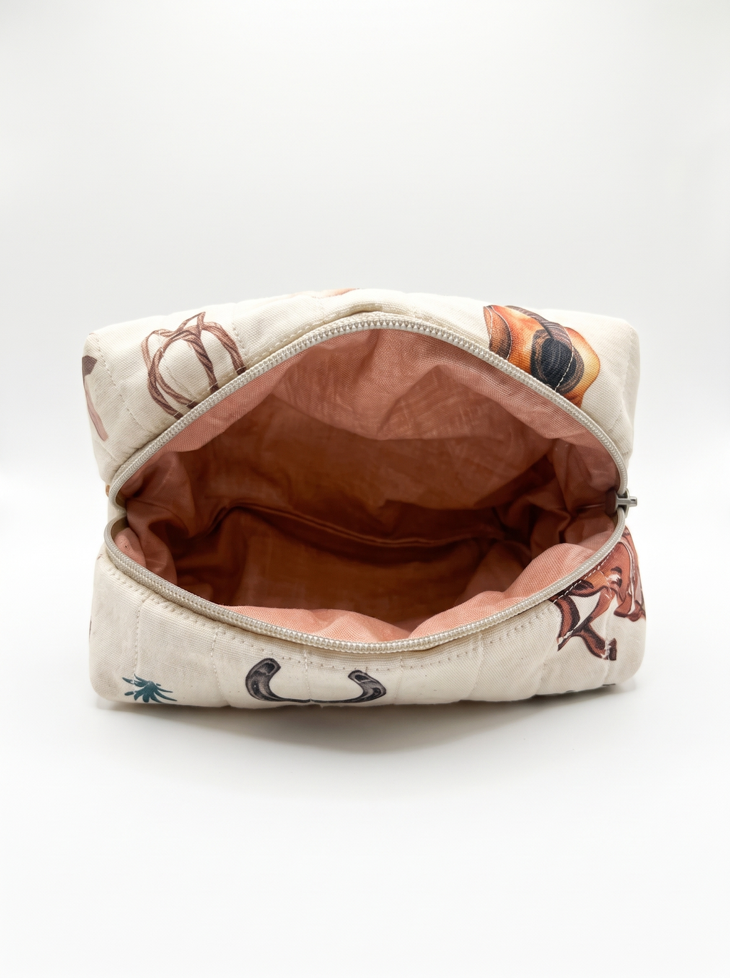 An open zippered cosmetic pouch with a cream-colored exterior featuring a brown and orange horse pattern, and a dusty rose pink interior lining.