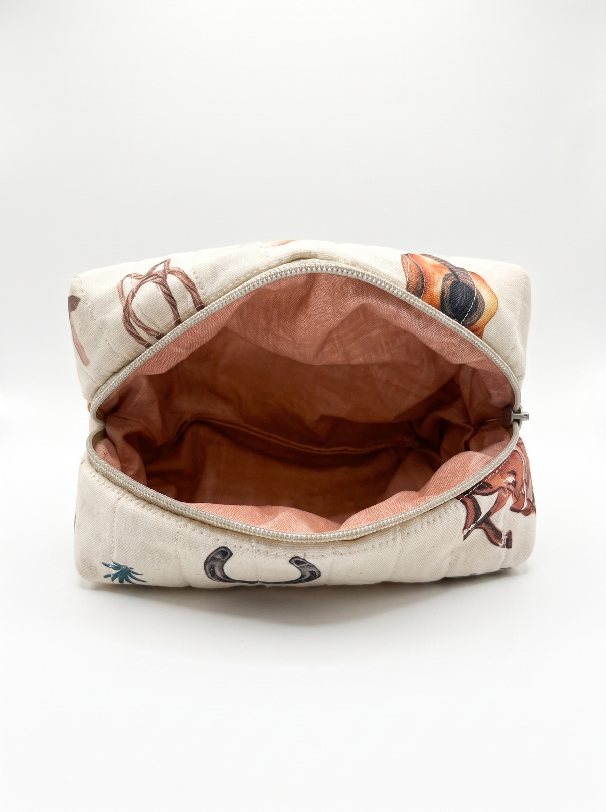 An open zippered cosmetic pouch with a cream-colored exterior featuring a brown and orange horse pattern, and a dusty rose pink interior lining.